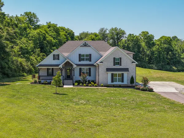 a front view of house with yard and green space