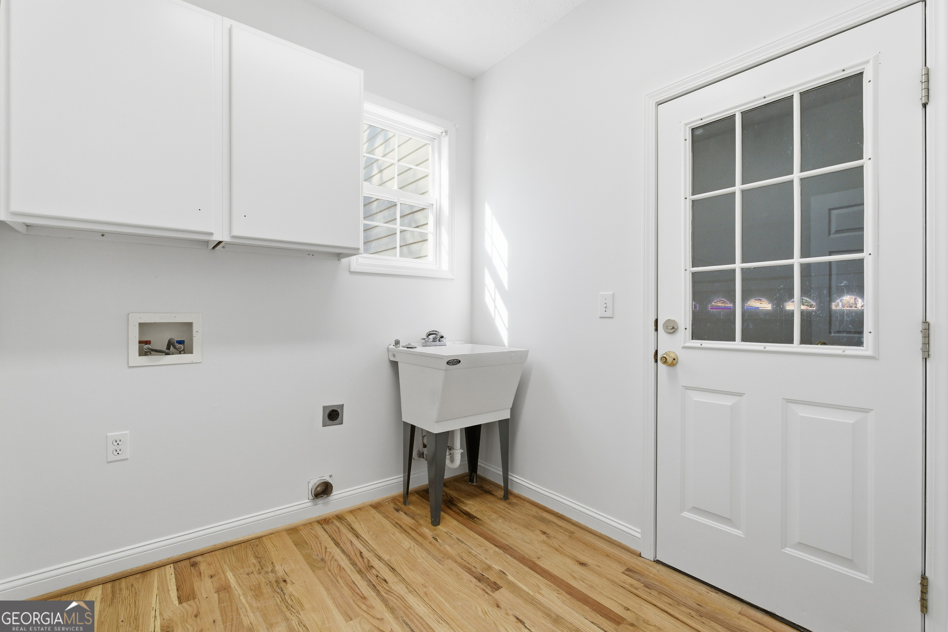 1217 Monticello Drive Villa Rica, GA 30180 - Photo 21 of 36 a view of an empty room with window and wooden floor