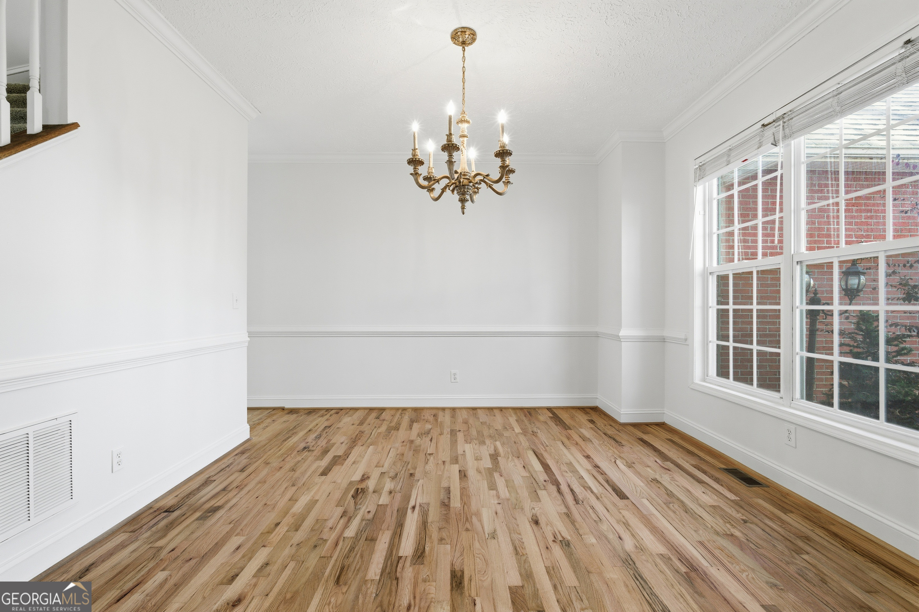 1217 Monticello Drive Villa Rica, GA 30180 - Photo 4 of 36 a view of a room with wooden floor and a ceiling fan