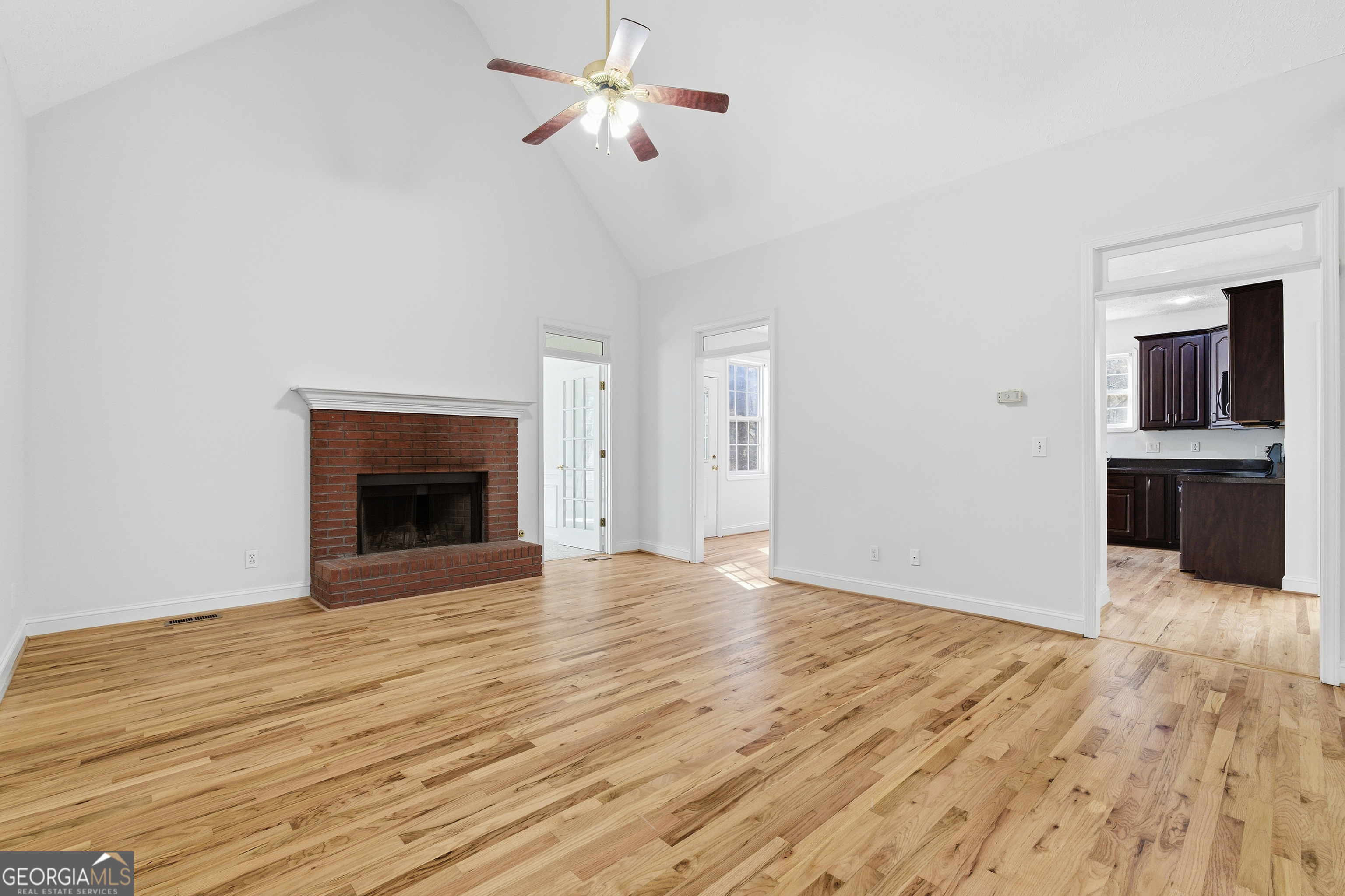 1217 Monticello Drive Villa Rica, GA 30180 - Photo 6 of 36 a view of empty room with wooden floor and fireplace