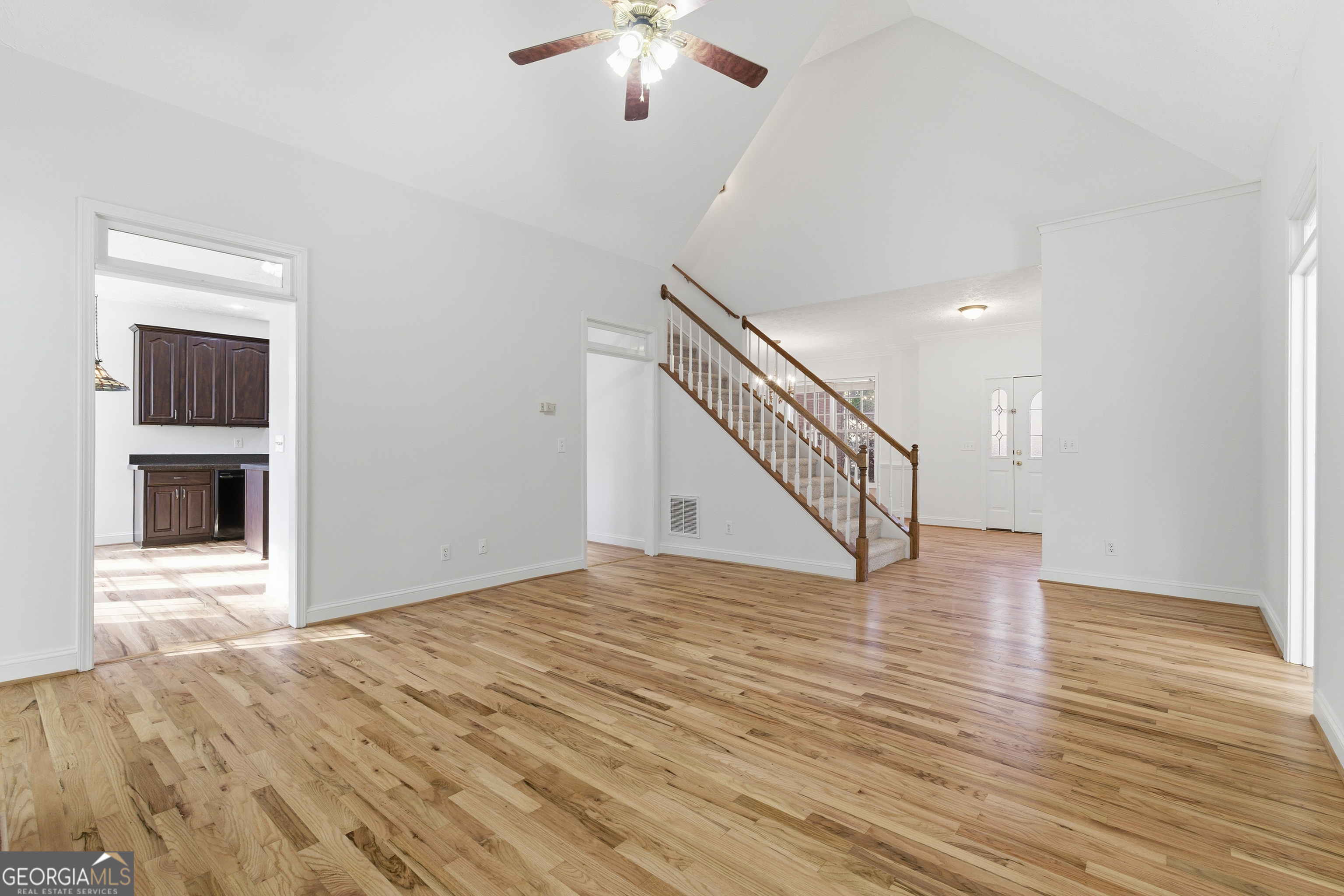 1217 Monticello Drive Villa Rica, GA 30180 - Photo 7 of 36 a view of an empty room with wooden floor and a ceiling fan
