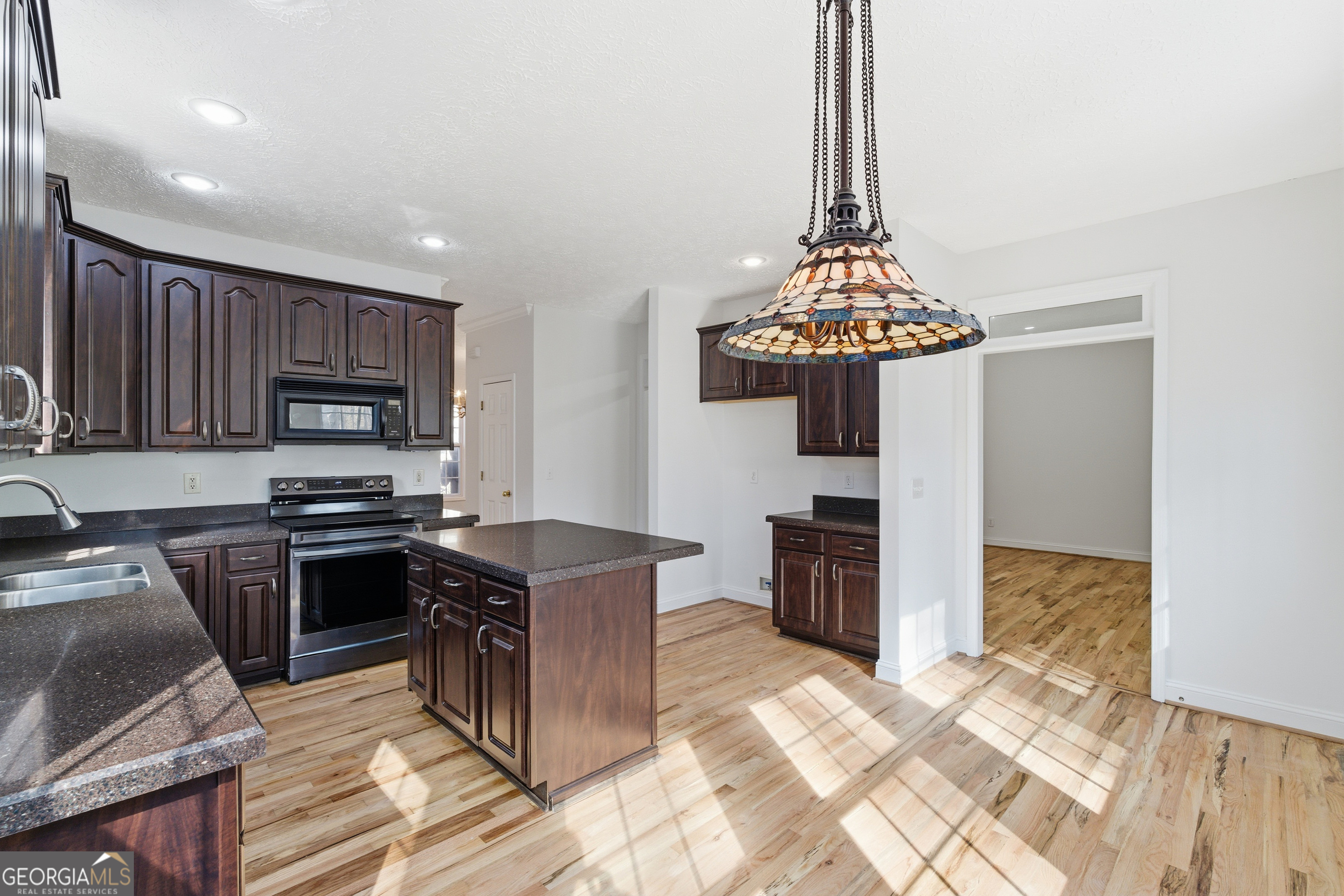 1217 Monticello Drive Villa Rica, GA 30180 - Photo 9 of 36 a kitchen with stainless steel appliances granite countertop a stove refrigerator and a sink
