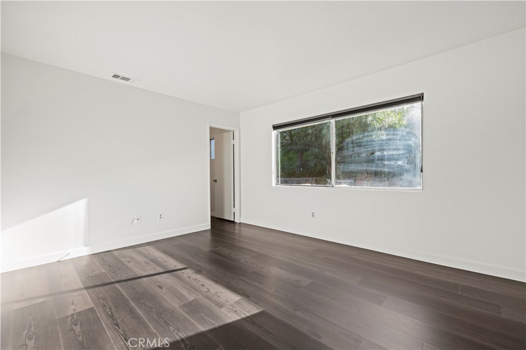 28014 Fox Run Circle Castaic, CA 91384 - Photo 11 of 27 an empty room with wooden floor and windows