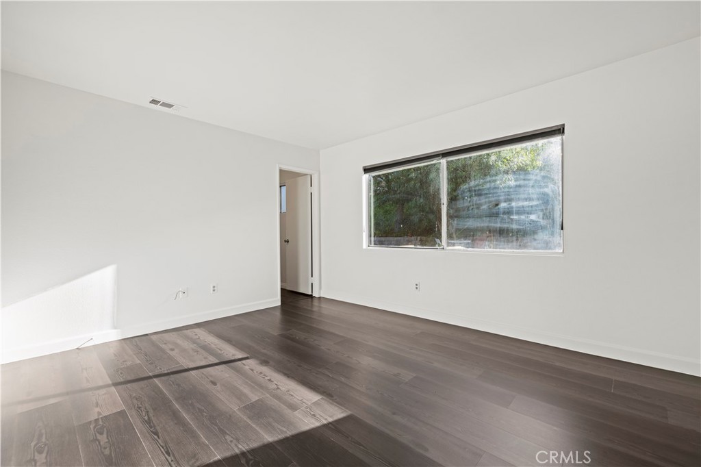28014 Fox Run Circle Castaic, CA 91384 - Photo 12 of 27 an empty room with wooden floor and windows