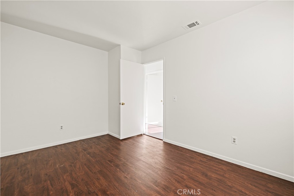 28014 Fox Run Circle Castaic, CA 91384 - Photo 14 of 27 an empty room with wooden floor