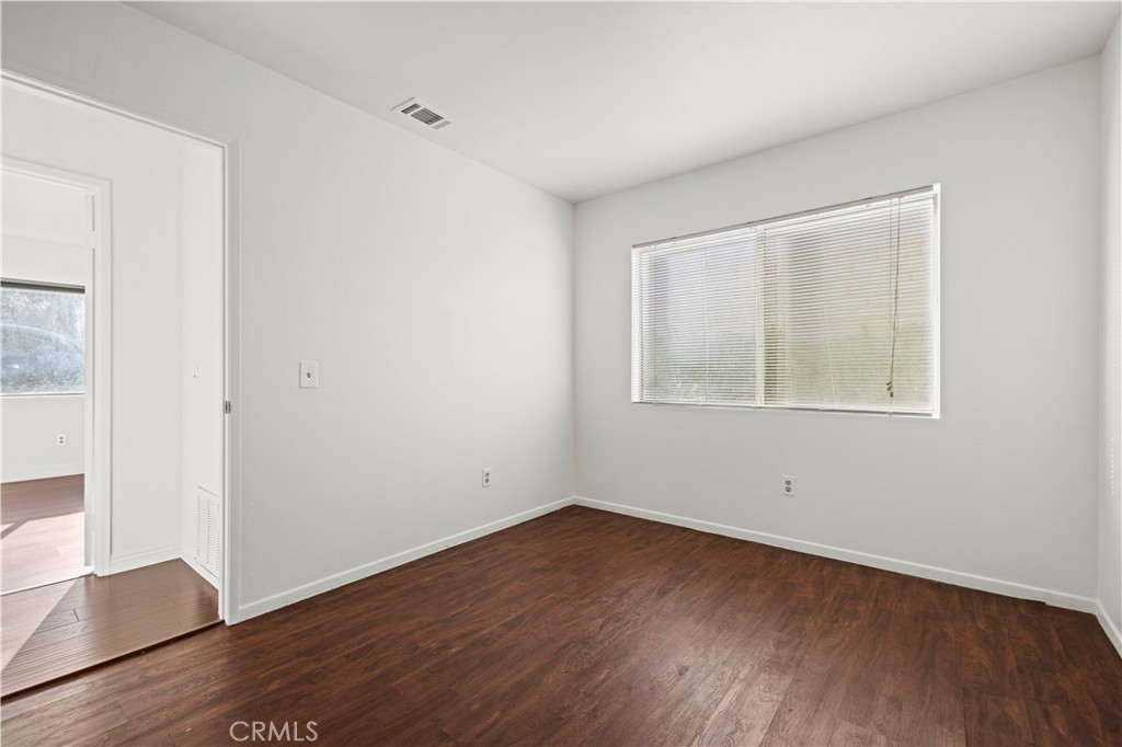 28014 Fox Run Circle Castaic, CA 91384 - Photo 15 of 27 an empty room with wooden floor and windows