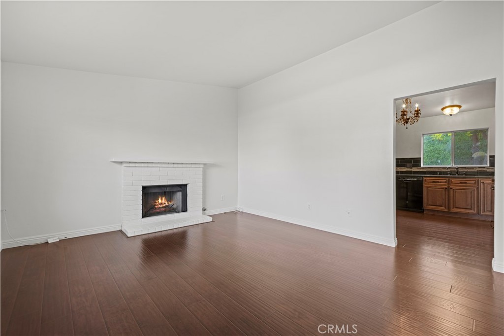28014 Fox Run Circle Castaic, CA 91384 - Photo 2 of 27 an empty room with wooden floor fireplace and windows
