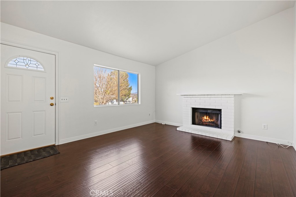28014 Fox Run Circle Castaic, CA 91384 - Photo 3 of 27 an empty room with wooden floor white walls and windows