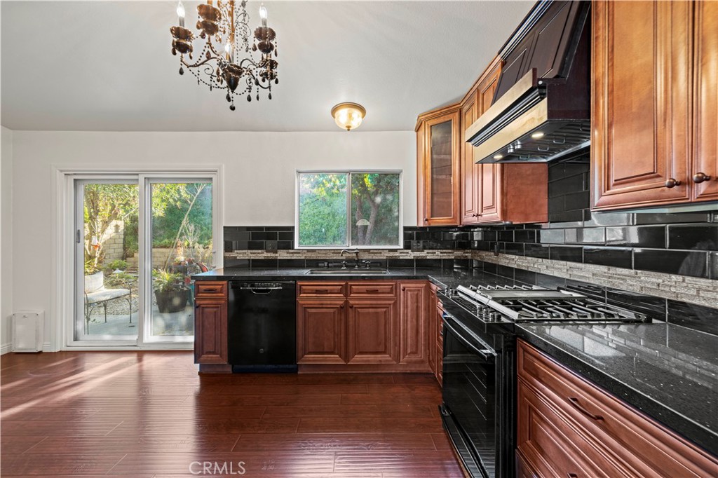 28014 Fox Run Circle Castaic, CA 91384 - Photo 6 of 27 a kitchen with stainless steel appliances granite countertop a stove a sink and a microwave