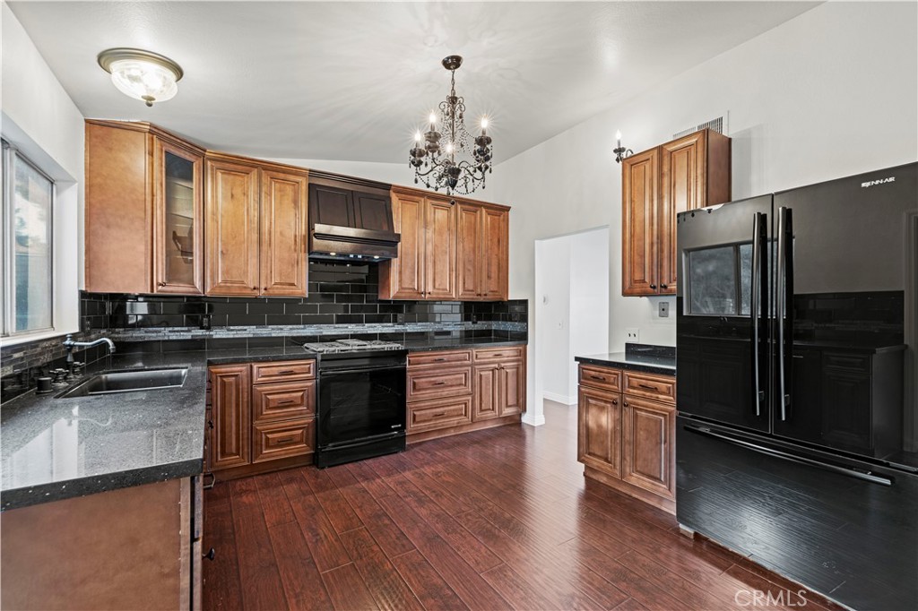 28014 Fox Run Circle Castaic, CA 91384 - Photo 7 of 27 a kitchen with granite countertop stainless steel appliances and wooden cabinets
