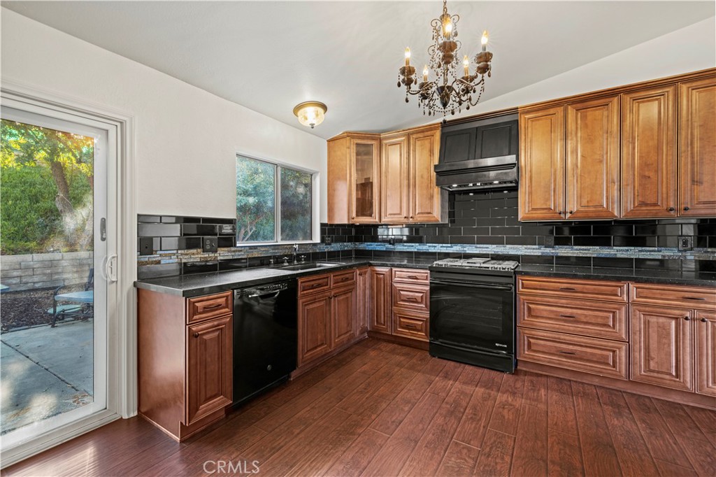 28014 Fox Run Circle Castaic, CA 91384 - Photo 8 of 27 a kitchen with stainless steel appliances granite countertop a stove a sink dishwasher and a microwave oven with cabinets
