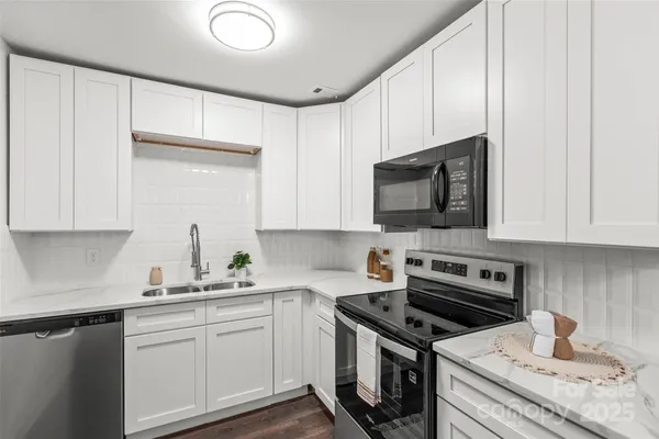 a kitchen with a sink stove and microwave