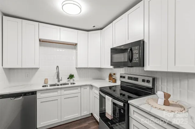 a kitchen with a sink stove and microwave