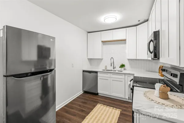 a kitchen with a sink and refrigerator