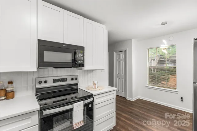 a kitchen with a stove and a microwave