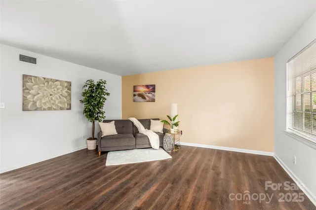 a living room with furniture and a potted plant