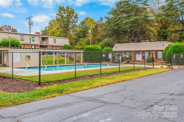 a view of a house with swimming pool and yard