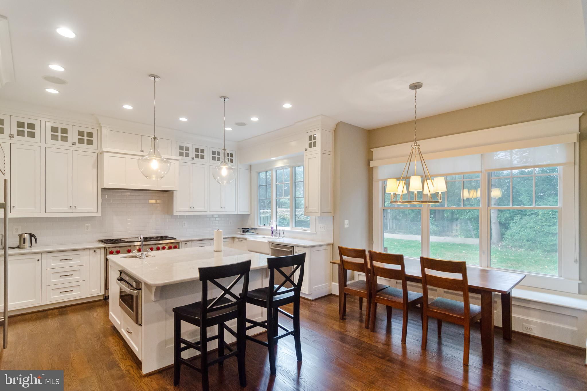 6801 Danforth Street McLean, VA 22101 - Photo 8 of 29 a kitchen with a table chairs stove and cabinets