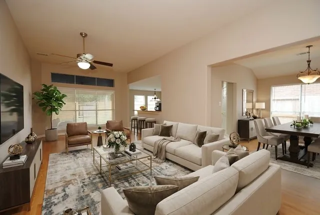 a living room with furniture potted plant and a window