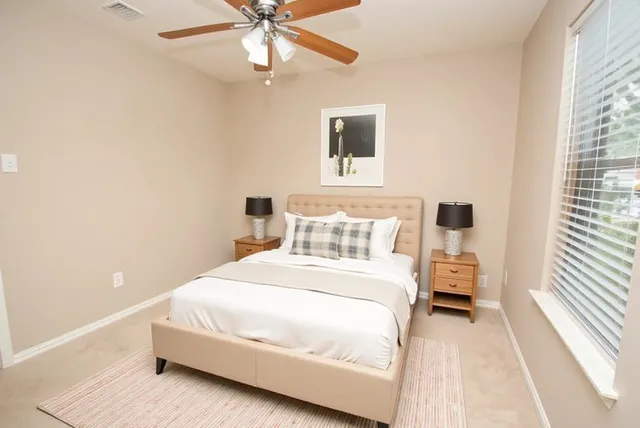 a bedroom with a bed and a white wall