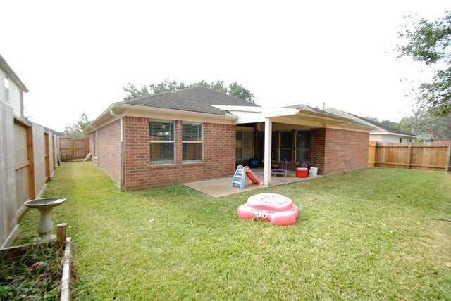 a backyard of a house with table and chairs