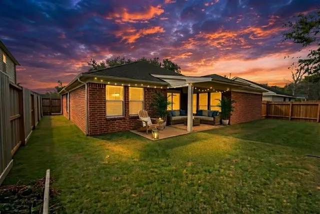 a view of a house with backyard porch and sitting area