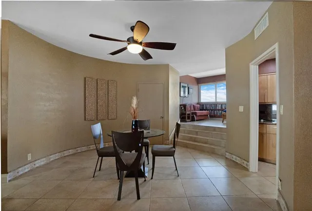 a dining room with furniture and window