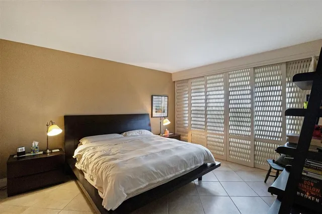 a bedroom with a bed and a painting on the wall