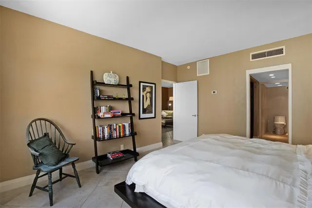 a en suite bathroom with a granite countertop sink and mirror