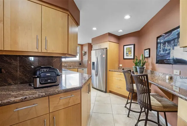 a bathroom with a sink and a large mirror next to a window