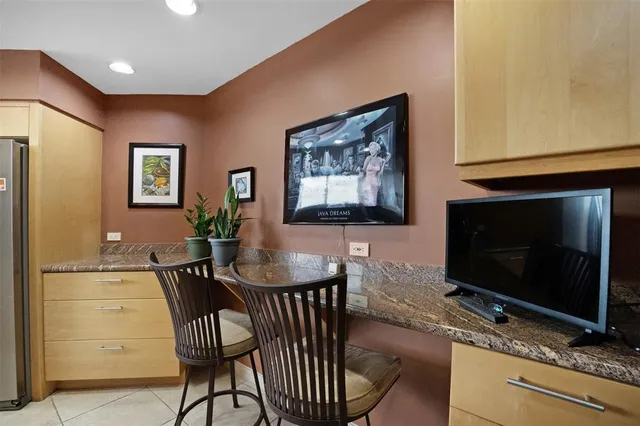 a kitchen with granite countertop a refrigerator a stove and a sink