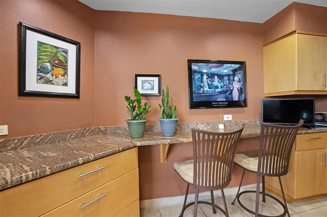 a view of a dining room with furniture and a chandelier fan