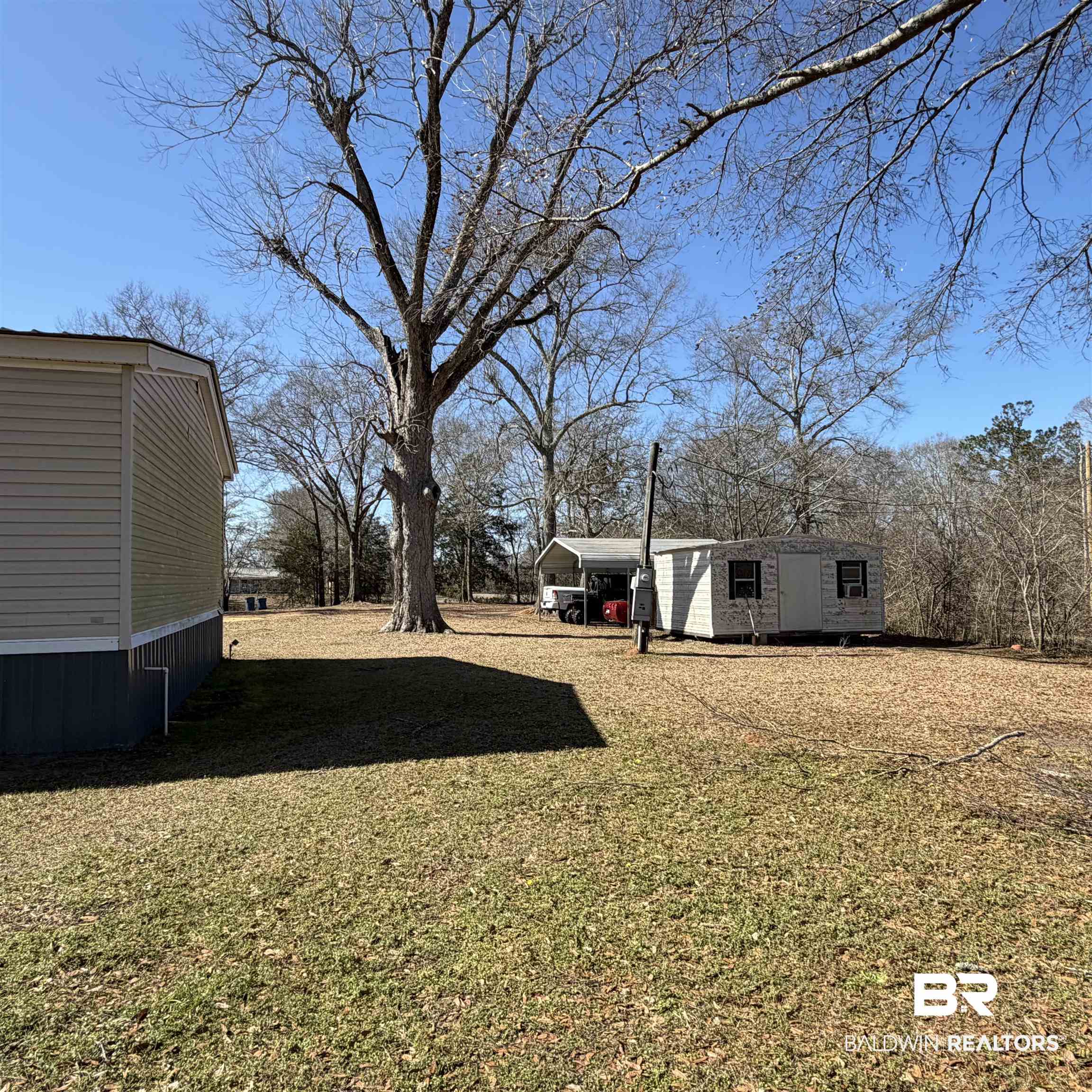 447 Sugar Hill Road Monroeville, AL 36460 - Photo 25 of 27 View of green lawn featuring an outbuilding