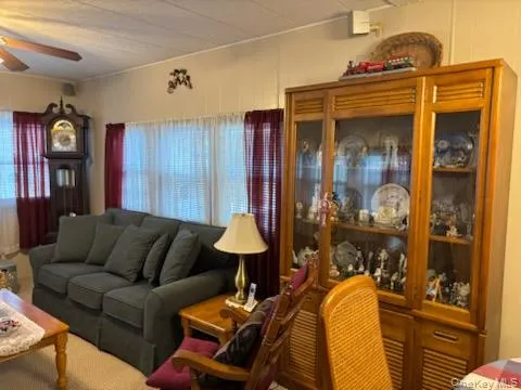 a living room filled with furniture and a window