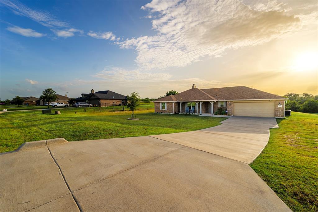 129 Springwood Ranch Loop Springtown, TX 76082 - Photo 29 of 29 Brick exterior with a covered front porch and white columns