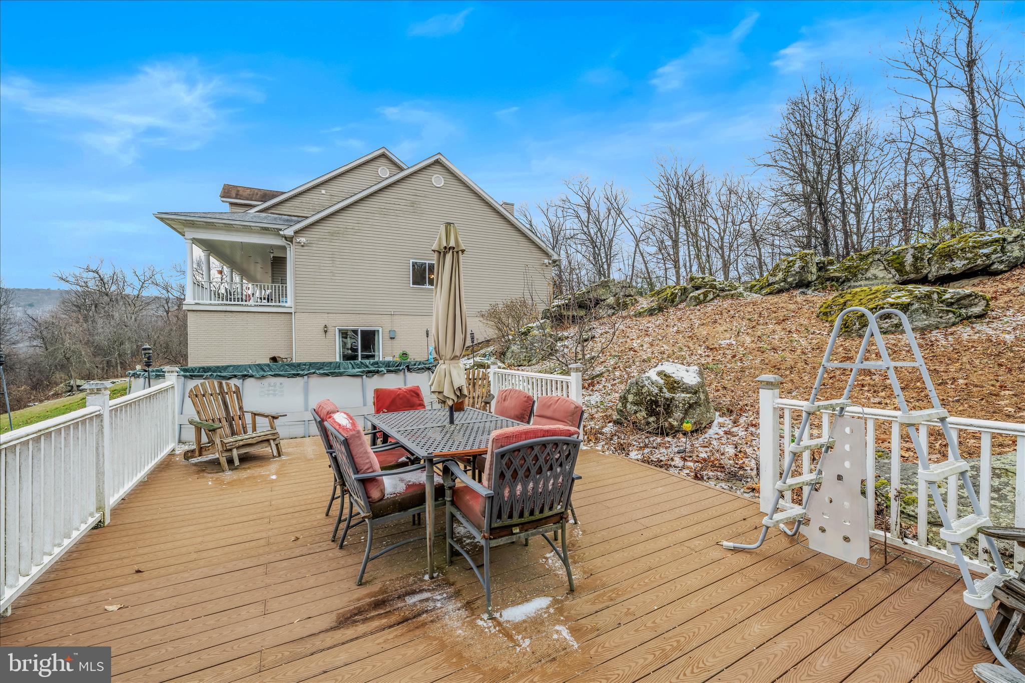 7020 Debold Road Thurmont, MD 21788 - Photo 71 of 83 a view of a roof deck with table and chairs with wooden floor and fence