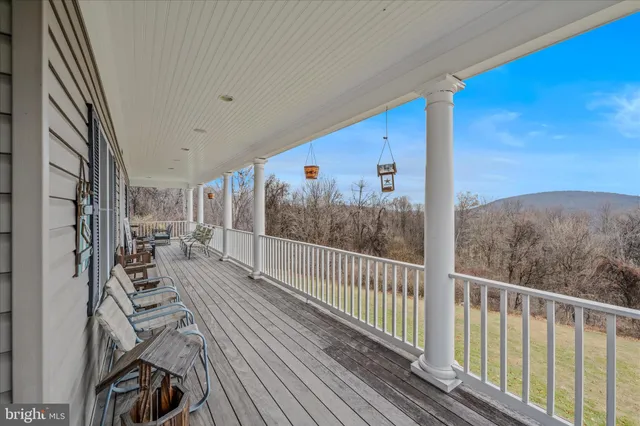 a view of balcony with chairs and wooden fence