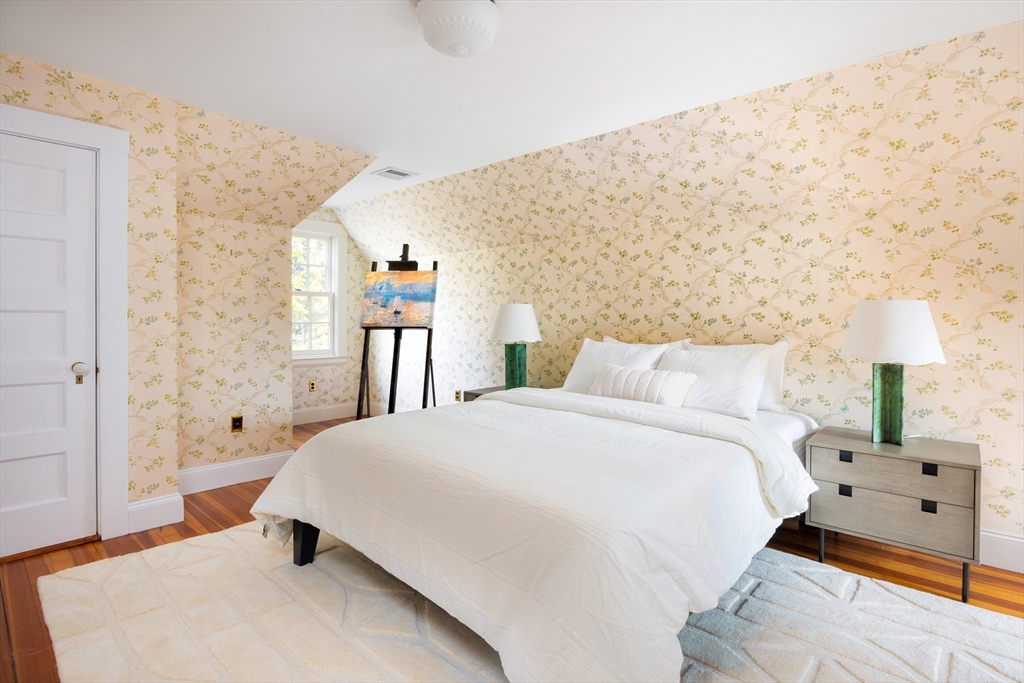 15 Hubbard Park Road Cambridge, MA 02138 - Photo 25 of 31 a spacious bedroom with a bed and a lamp on table