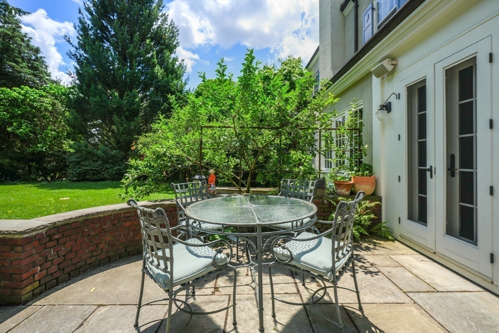 15 Hubbard Park Road Cambridge, MA 02138 - Photo 31 of 31 a patio with table and chairs and potted plants