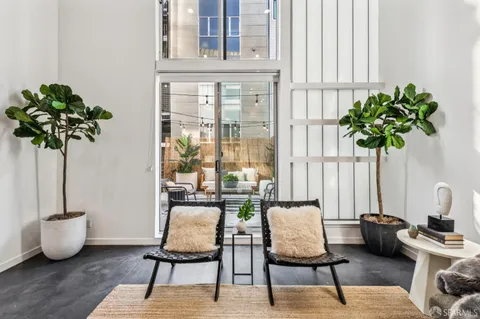 a view of a patio with a table and chairs and potted plants