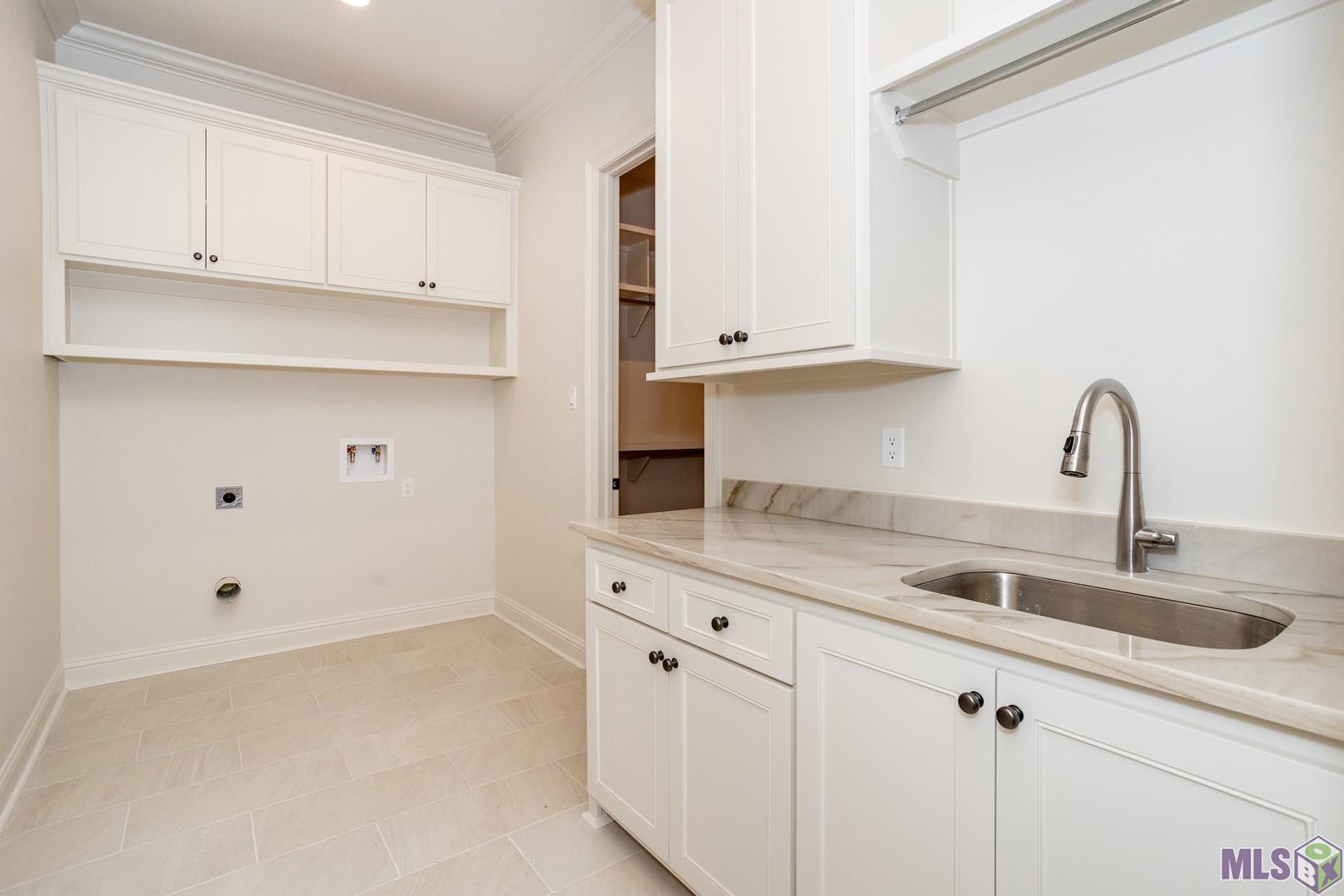 2127 Stableford Lane Baton Rouge, LA 70809 - Photo 23 of 46 Large Laundry with Sink and Convenient Access From the Primary Closet