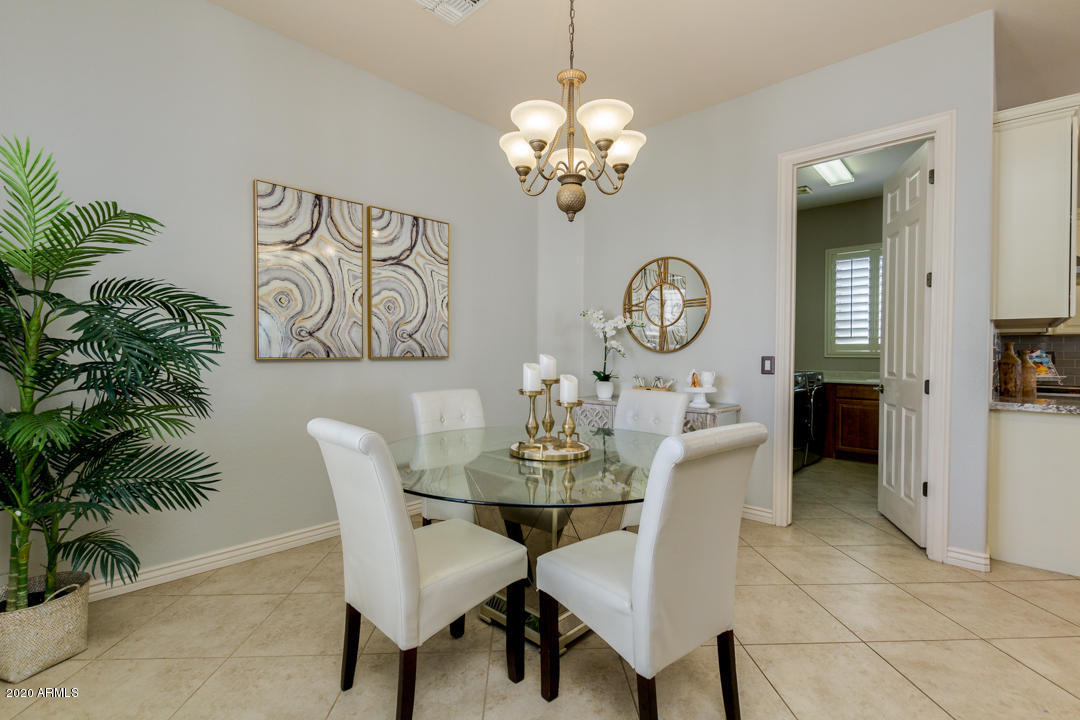 4640 East Reins Road Gilbert, AZ 85297 - Photo 27 of 122 a view of a dining room with furniture and chandelier