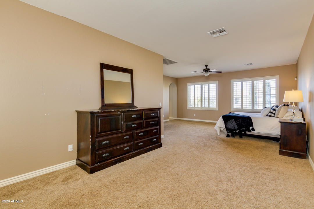 4640 East Reins Road Gilbert, AZ 85297 - Photo 36 of 122 a room with a bed and a television