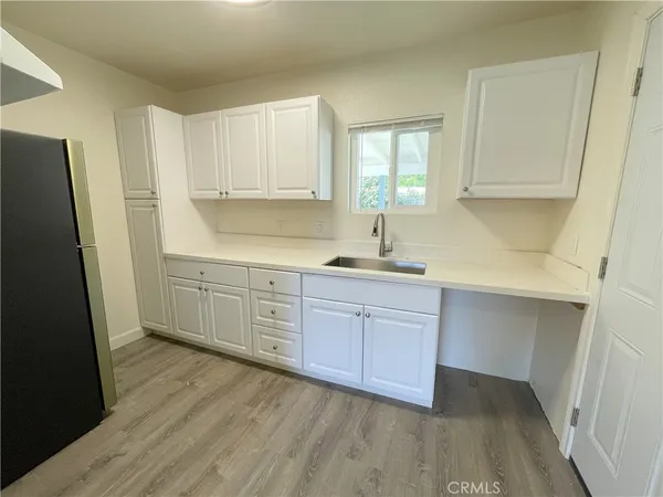 a kitchen with a sink window and cabinets