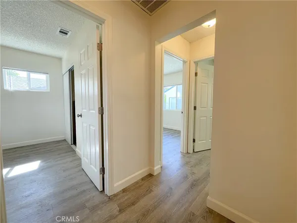 a view of a hallway with wooden floor