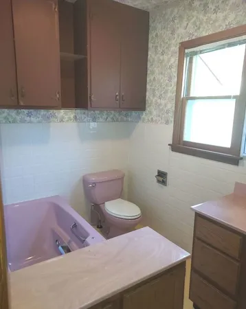a bathroom with a sink toilet and mirror
