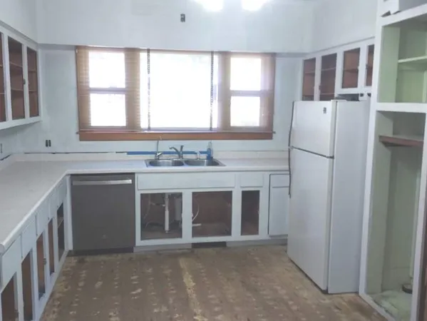 a kitchen with a sink and a window