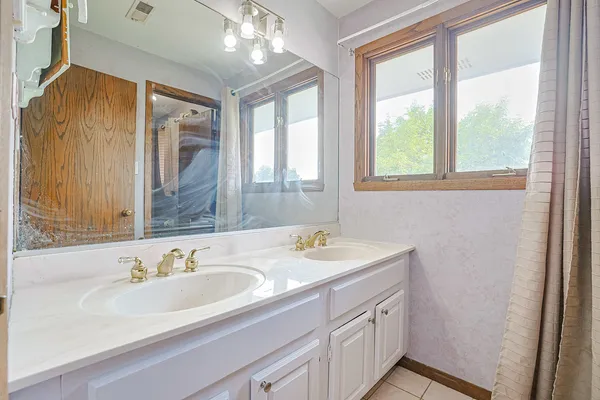 a bathroom with a sink double vanity and a mirror