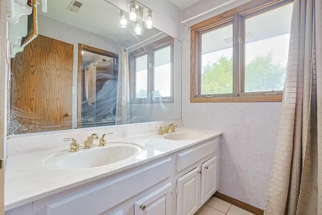 a bathroom with a sink double vanity and a mirror