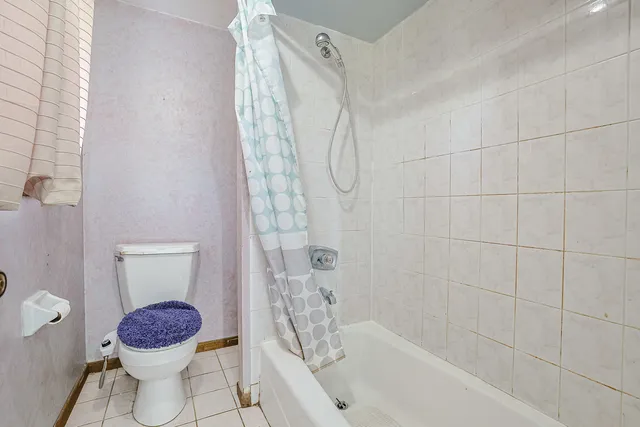 a bathroom with a toilet and shower